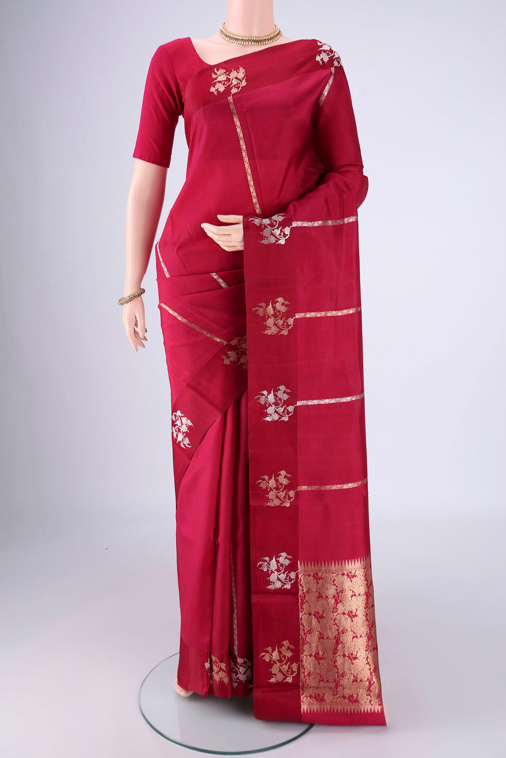 Maroon Banarasi Katan Silk Saree with Stripes on the body and Zari Border.  displayed on a mannequin