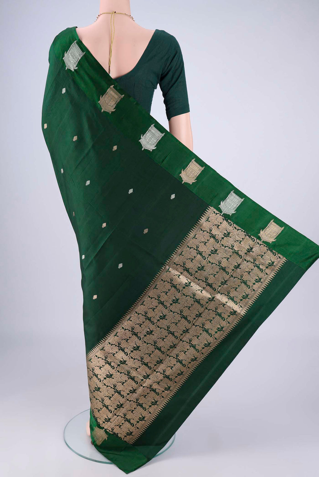 Flat view of Bottle Green Banarasi Katan Silk Saree with Zari Butta on the body and Satin Border. 