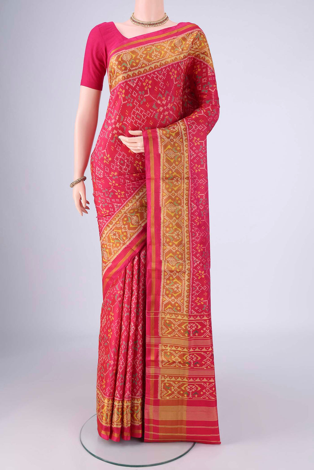 Dark Pink Rajkot Patola Silk Saree with Pure Ikat on the body and Ikat Border.  displayed on a mannequin