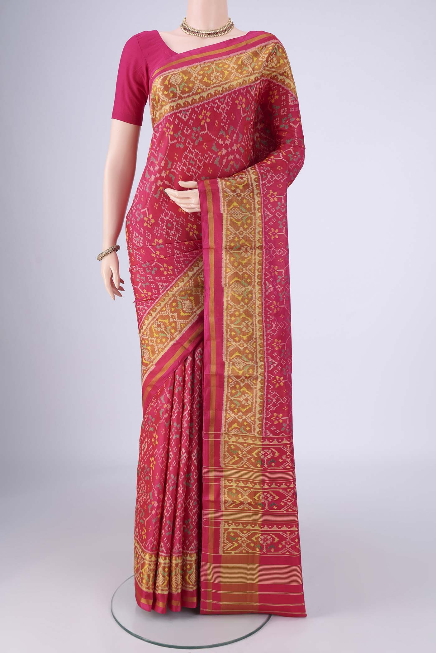 Dark Pink Rajkot Patola Silk Saree with Pure Ikat on the body and Ikat Border.  displayed on a mannequin