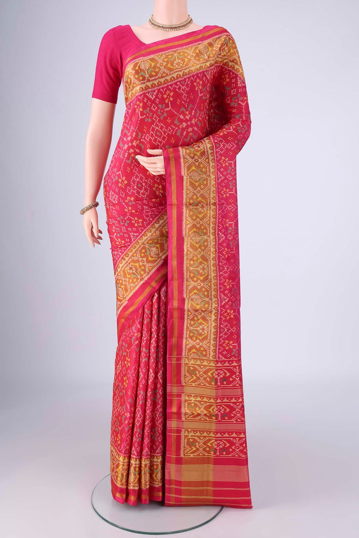 Dark Pink Rajkot Patola Silk Saree with Pure Ikat on the body and Ikat Border.  displayed on a mannequin