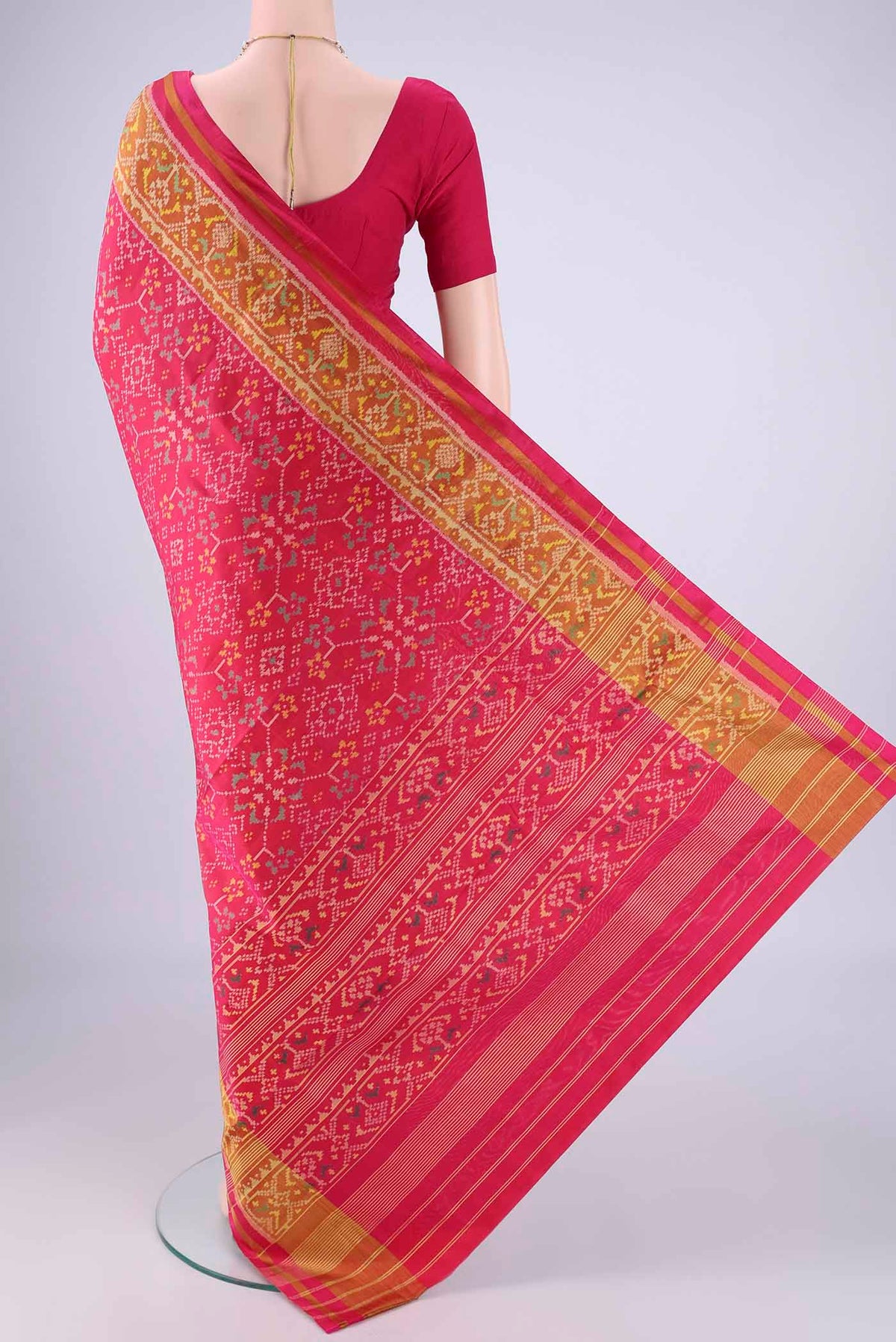 Flat view of Dark Pink Rajkot Patola Silk Saree with Pure Ikat on the body and Ikat Border. 