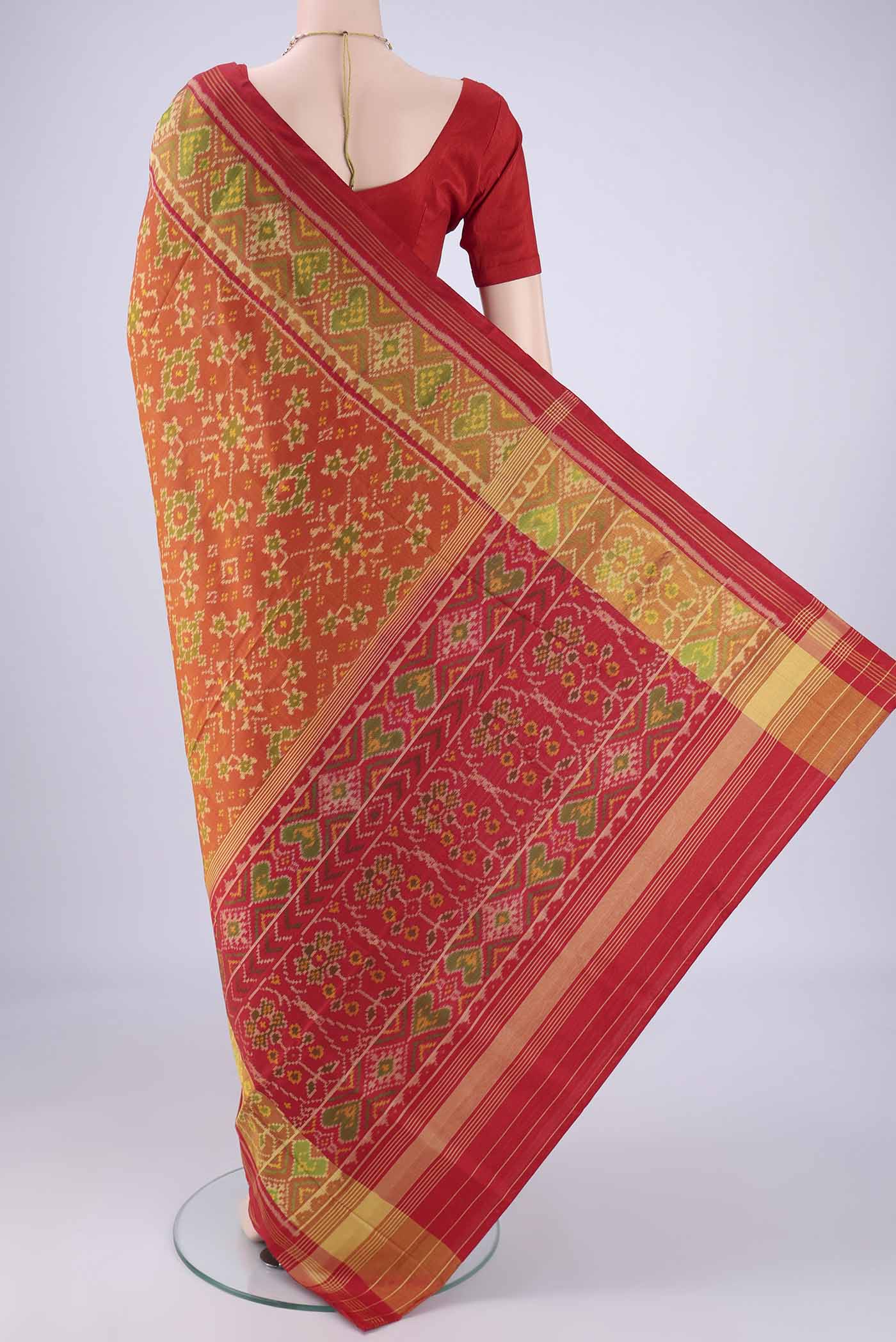 Flat view of Brick Orange Rajkot Patola Silk Saree with Pure Ikat on the body and Ikat Border. 