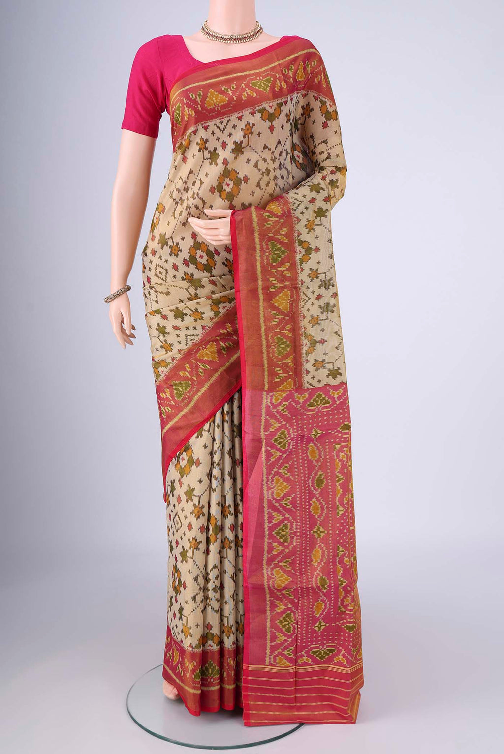 Beige Rajkot Patola Silk Saree with Pure Ikat on the body and Ikat Border.  displayed on a mannequin
