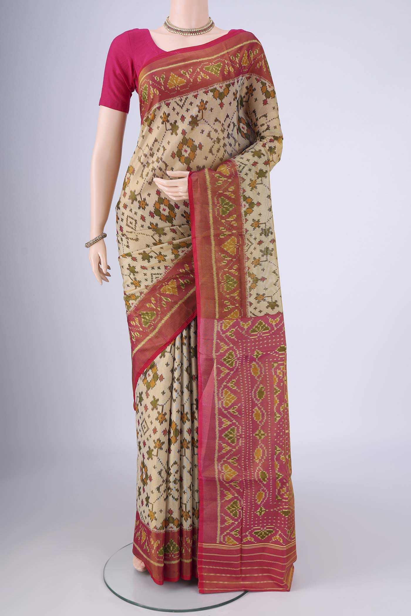 Beige Rajkot Patola Silk Saree with Pure Ikat on the body and Ikat Border.  displayed on a mannequin