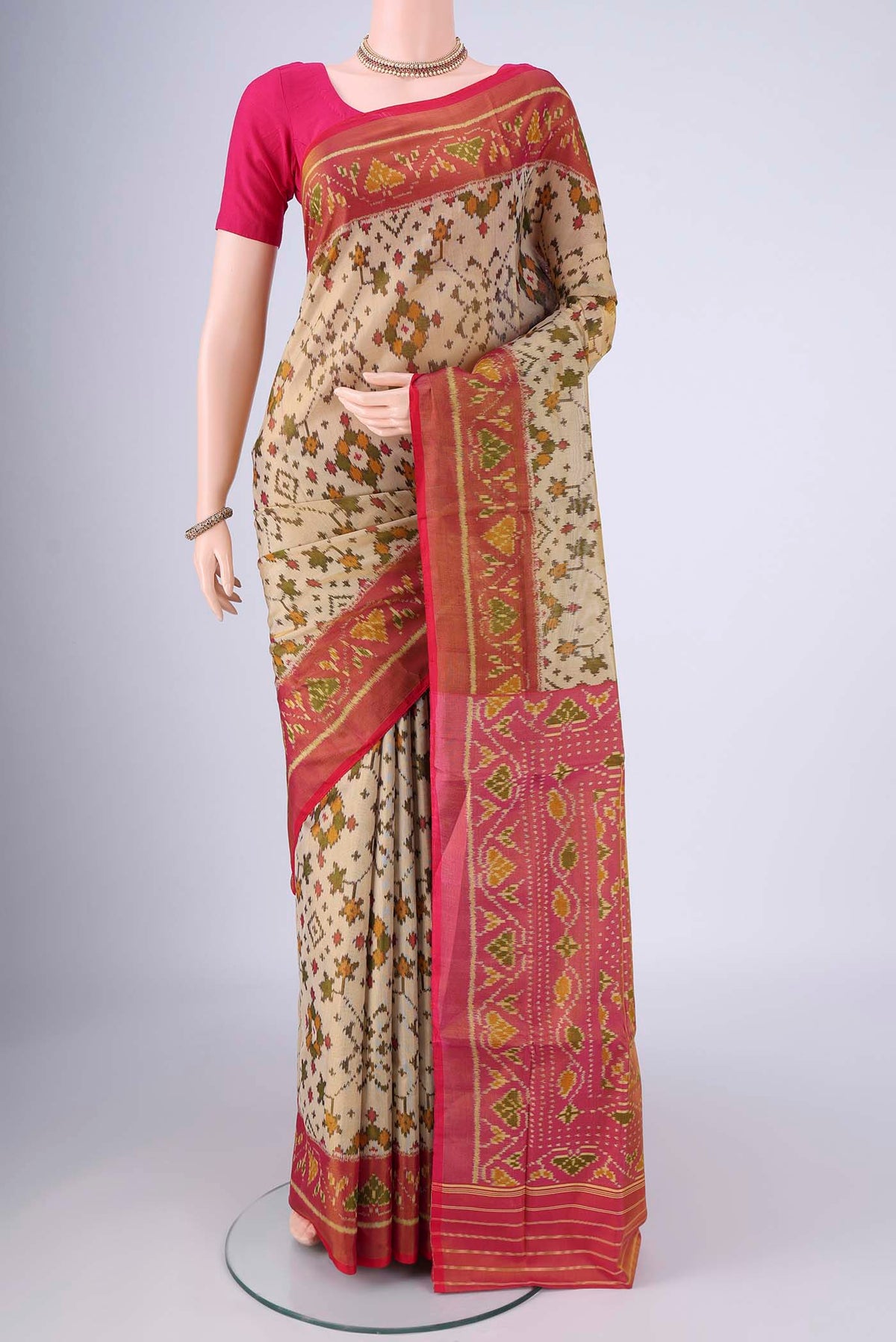 Beige Rajkot Patola Silk Saree with Pure Ikat on the body and Ikat Border.  displayed on a mannequin