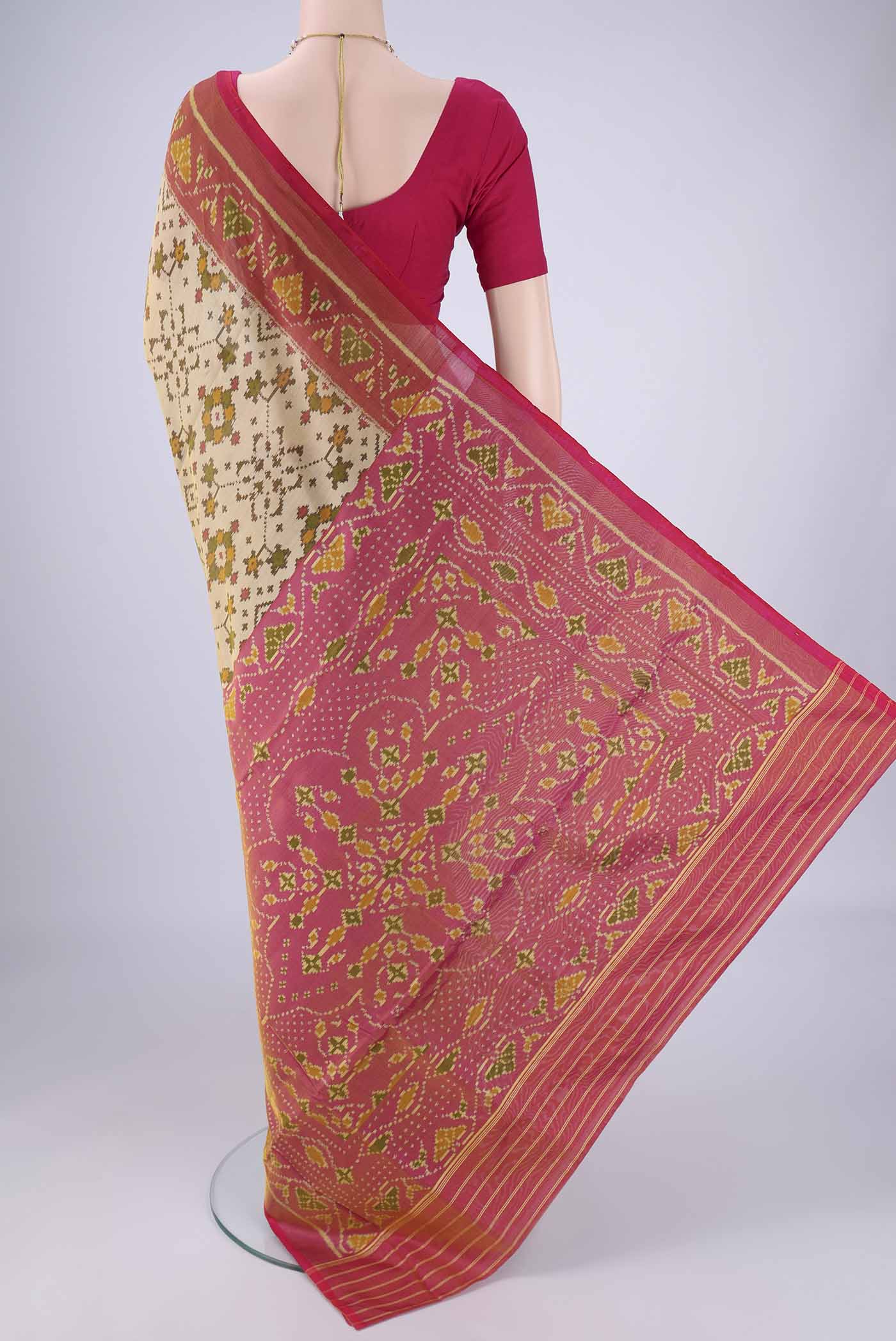 Flat view of Beige Rajkot Patola Silk Saree with Pure Ikat on the body and Ikat Border. 