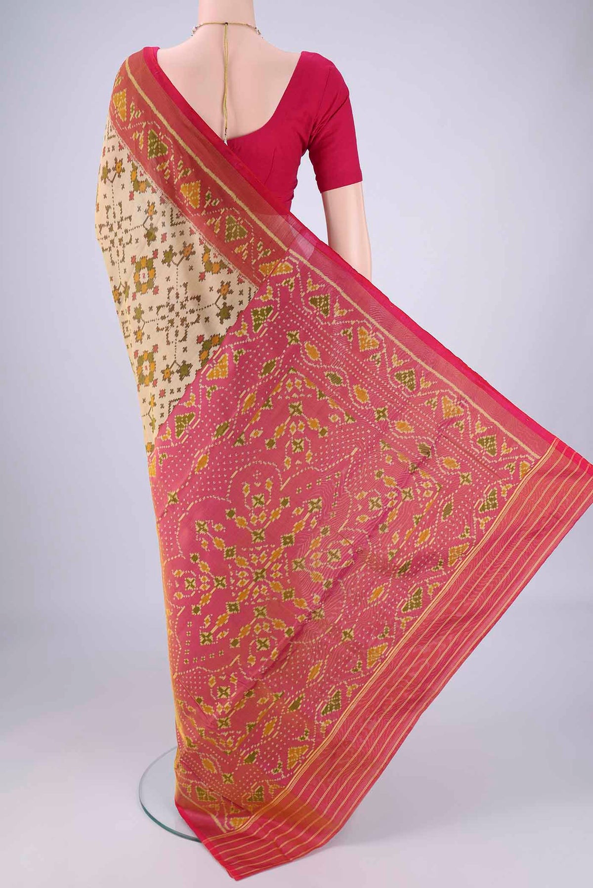 Flat view of Beige Rajkot Patola Silk Saree with Pure Ikat on the body and Ikat Border. 