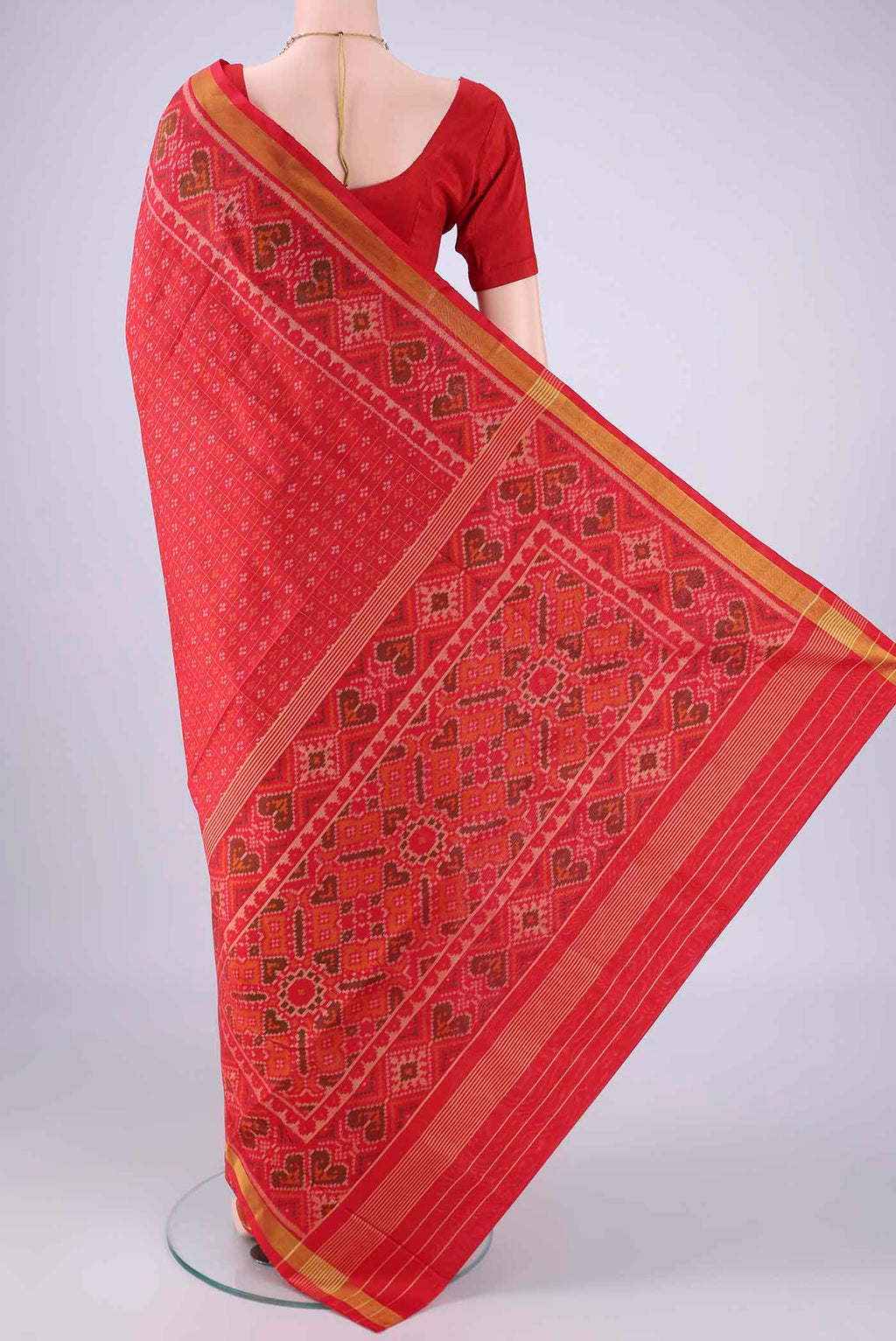 Flat view of Red Rajkot Patola Silk Saree with Ikat design on the body and Ikat Border. 