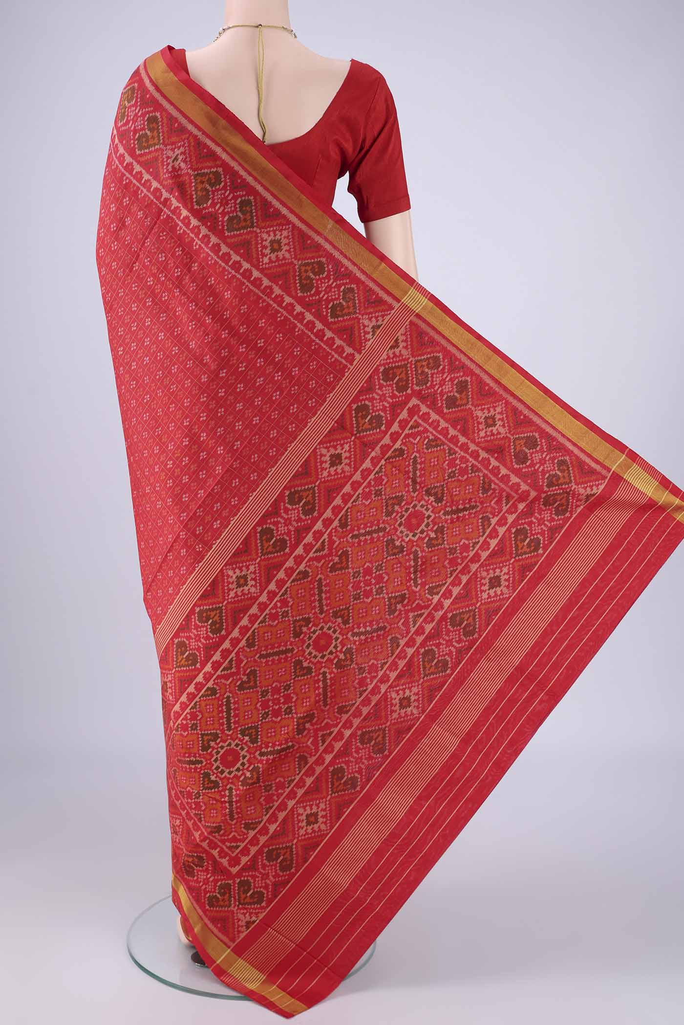 Flat view of Red Rajkot Patola Silk Saree with Ikat design on the body and Ikat Border. 