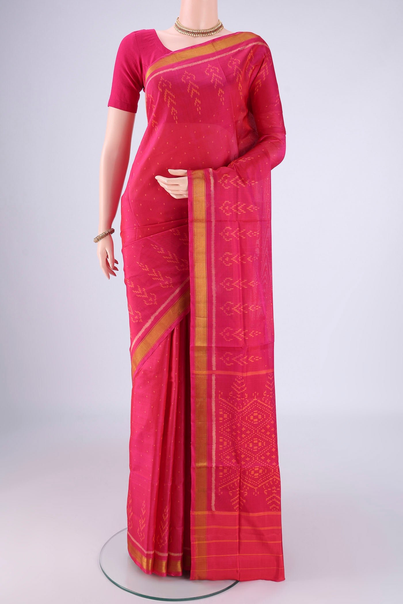 Dark Pink Rajkot Patola Silk Saree with Pure Ikat on the body and Ikat Border.  displayed on a mannequin