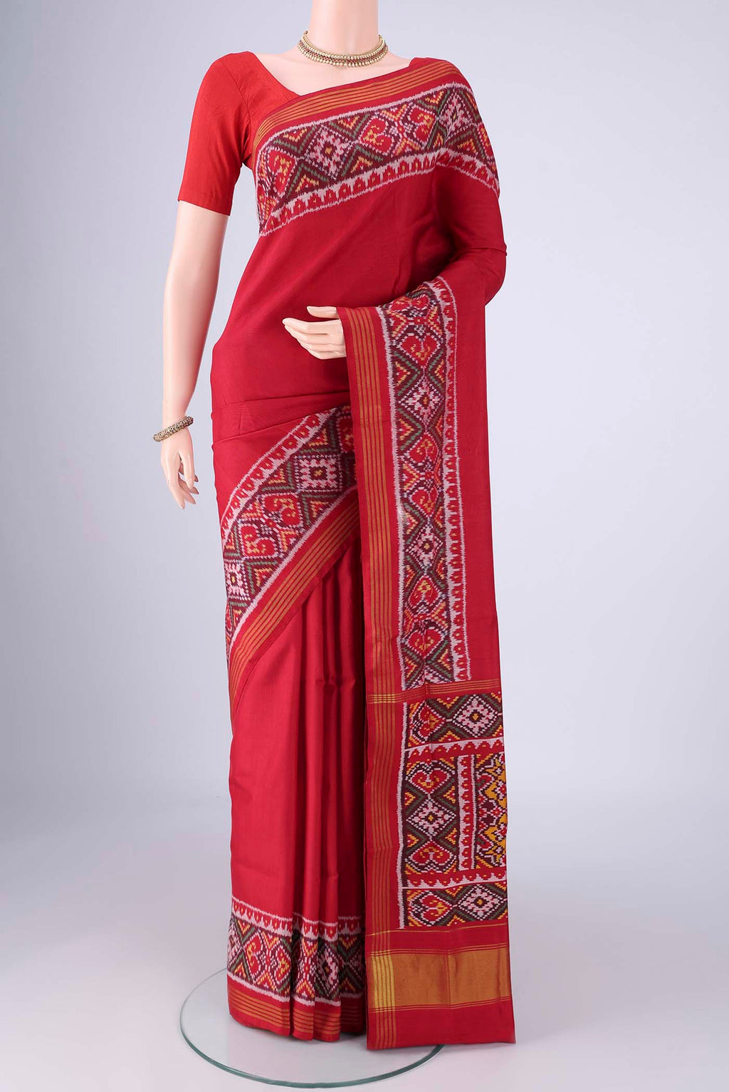 Red Rajkot Patola Silk Saree with Plain Body and Ikat Border.  displayed on a mannequin