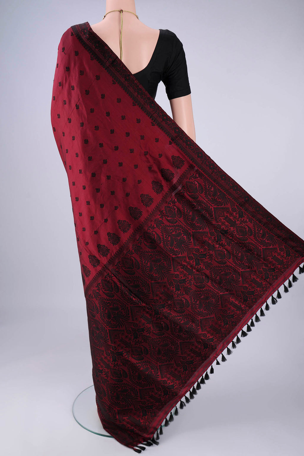 Flat view of Maroon Assam Silk Saree with Thread Butta on the body and Thread Border. 