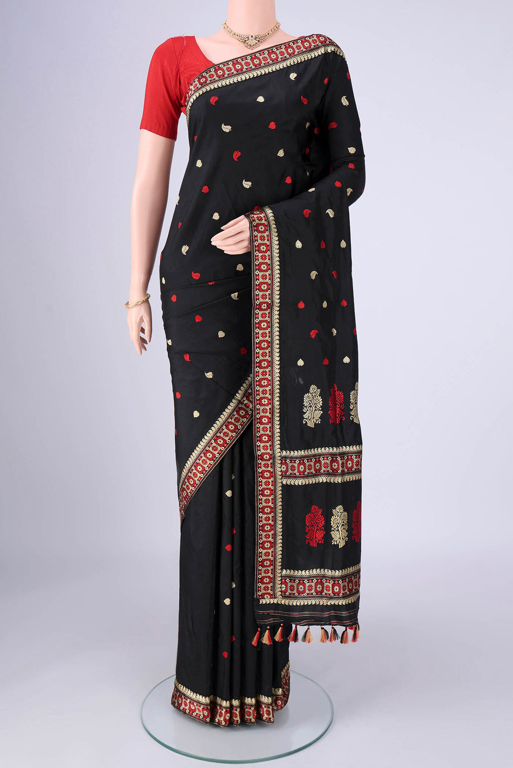 Black Assam Silk Saree with Thread Butta on the body and Thread Border.  displayed on a mannequin