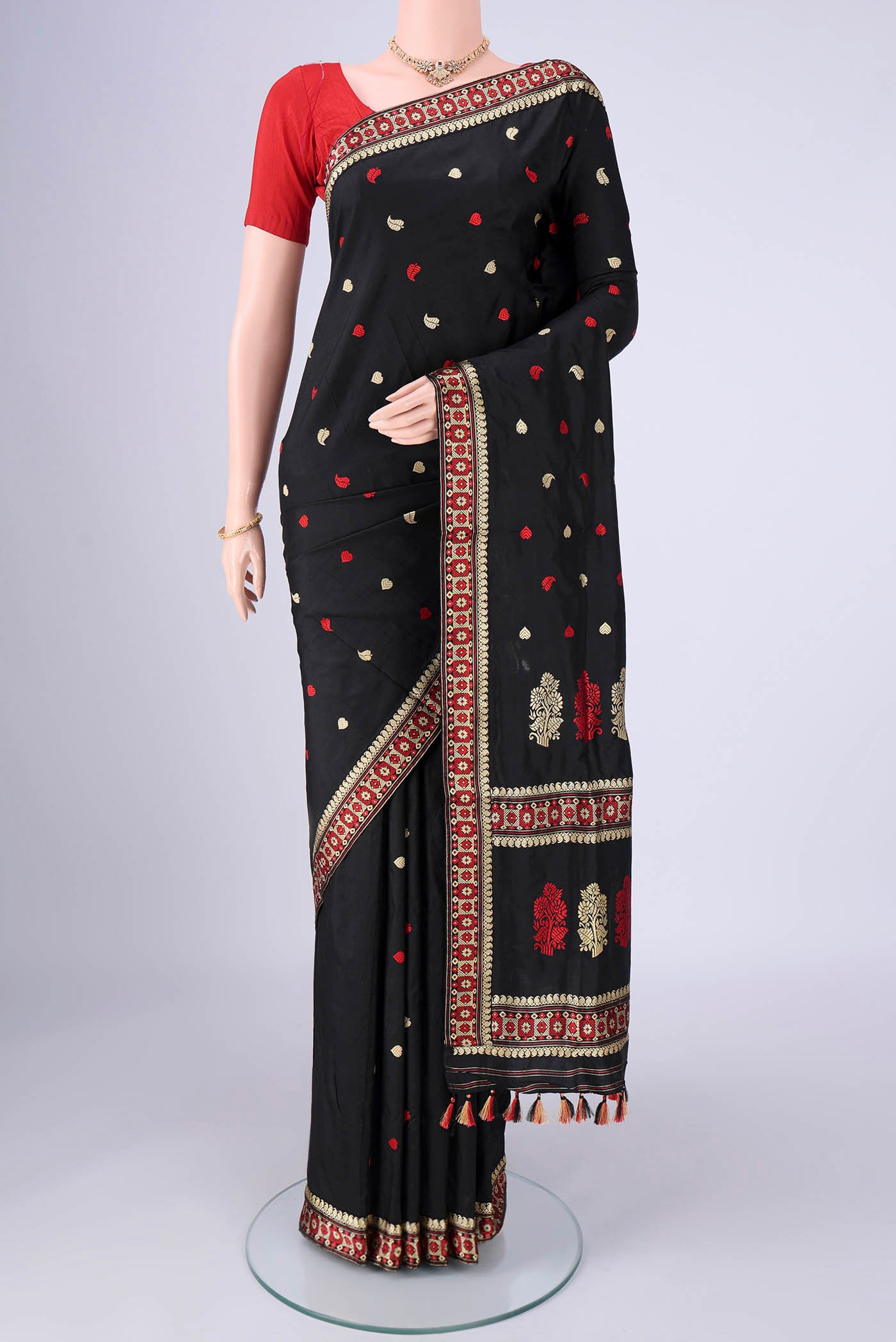 Black Assam Silk Saree with Thread Butta on the body and Thread Border.  displayed on a mannequin