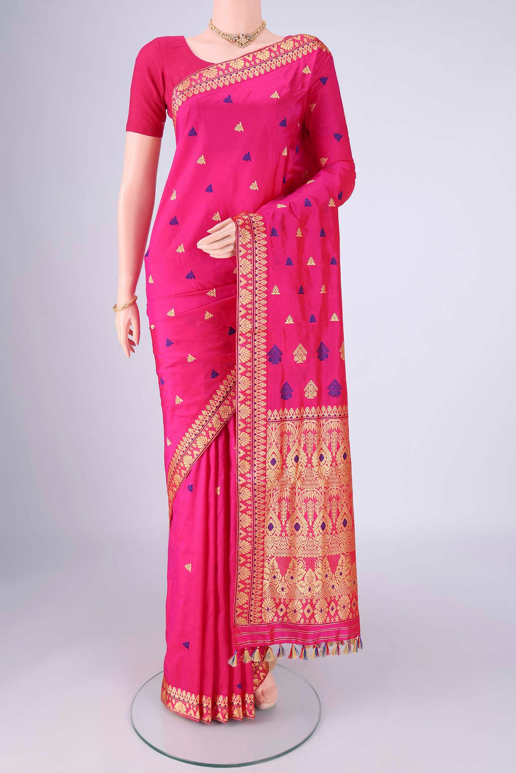 Rani Pink Assam Silk Saree with Thread Butta on the body and Thread Border.  displayed on a mannequin