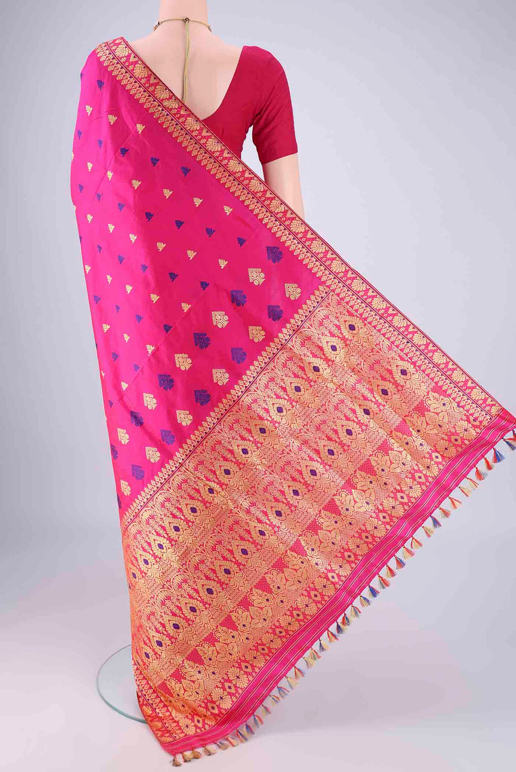 Flat view of Rani Pink Assam Silk Saree with Thread Butta on the body and Thread Border. 