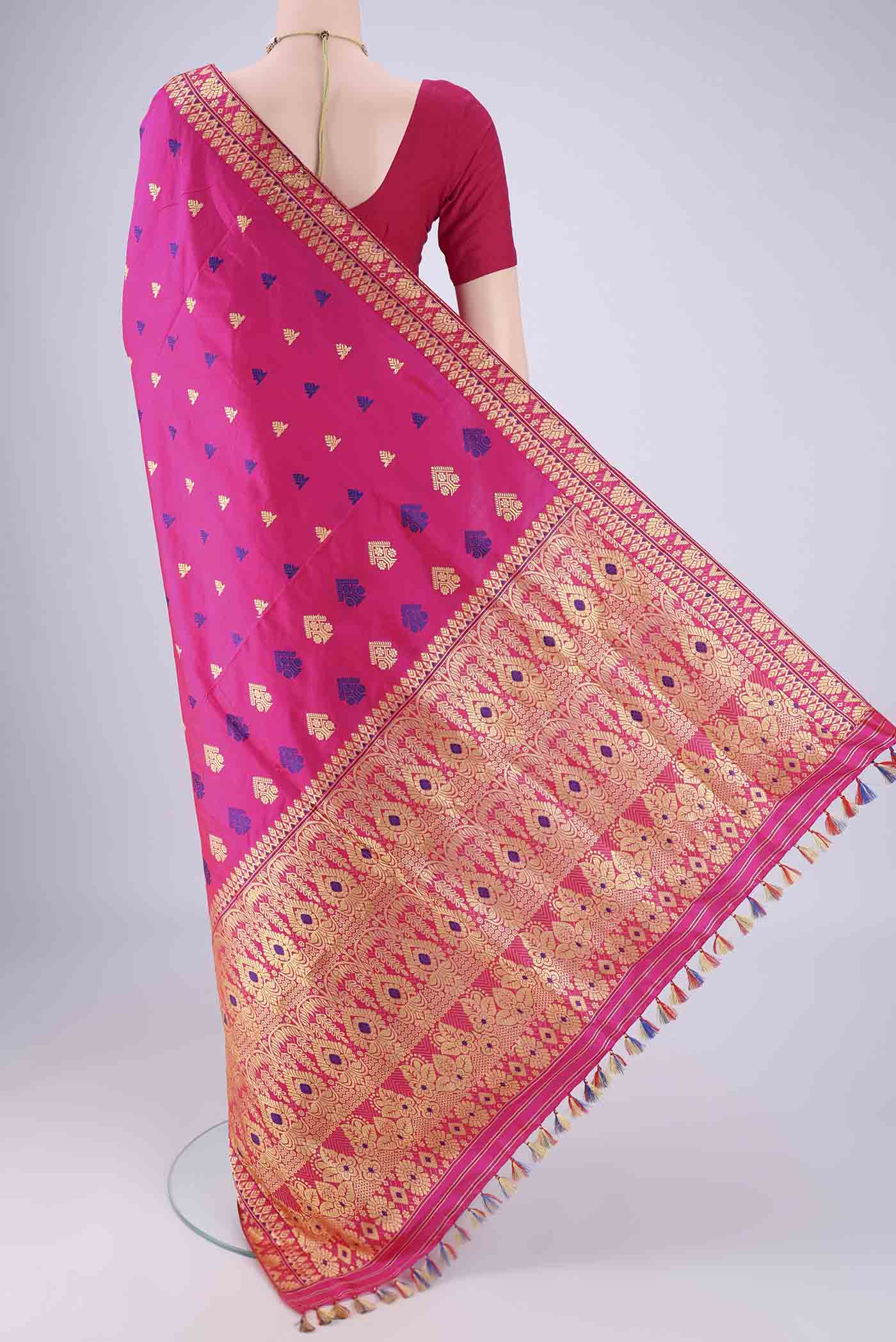 Flat view of Rani Pink Assam Silk Saree with Thread Butta on the body and Thread Border. 