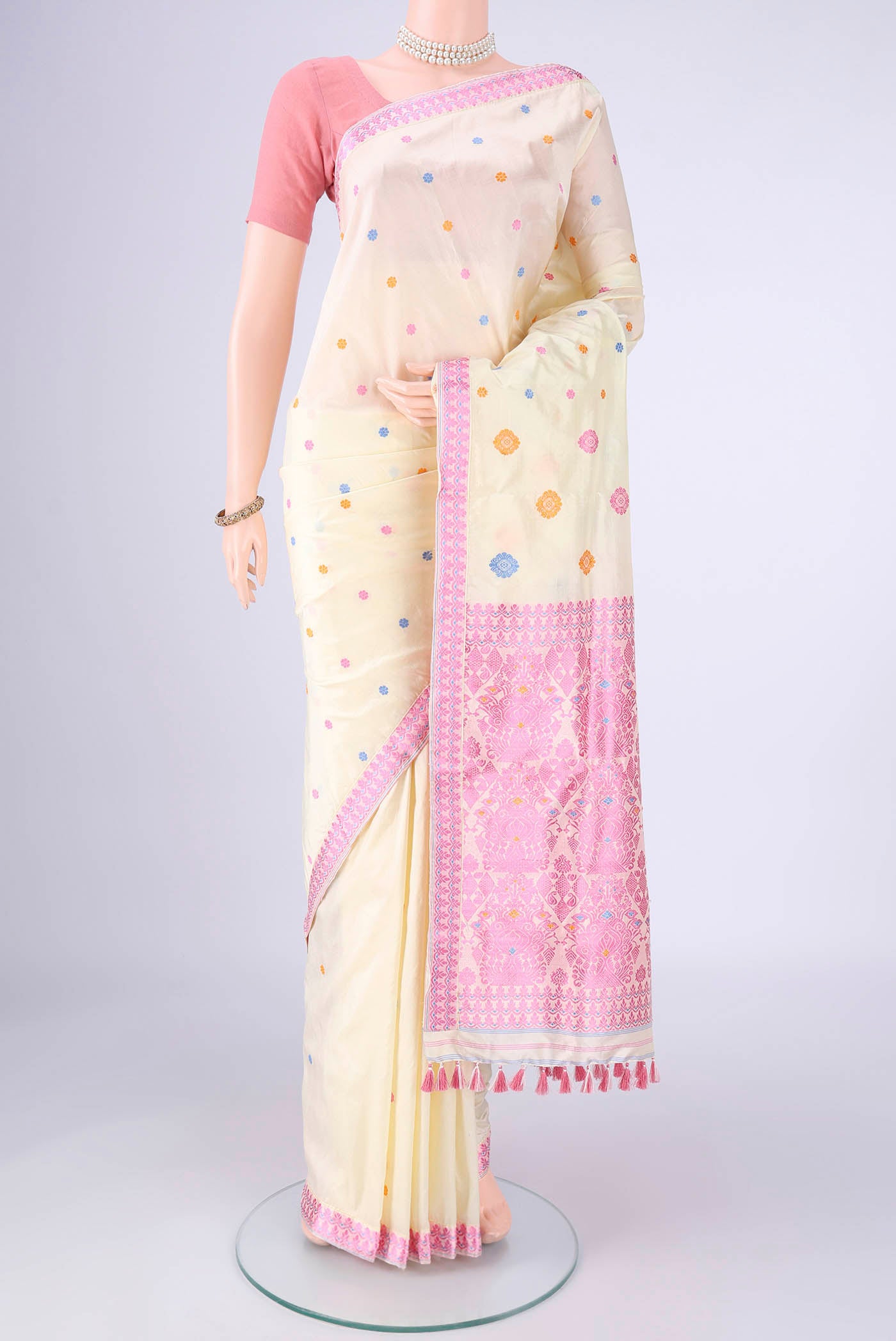 Off White Assam Silk Saree with Thread Butta on the body and Thread Border.  displayed on a mannequin
