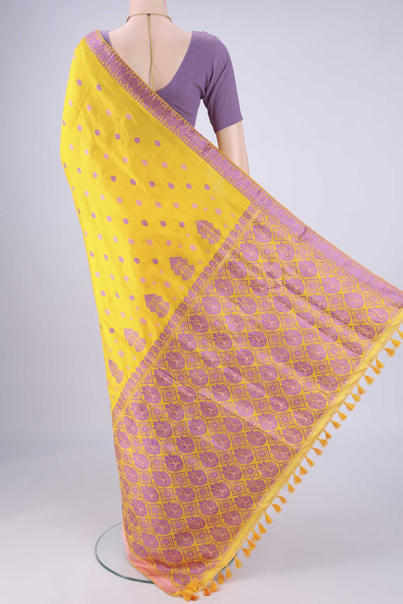 Flat view of Yellow Assam Silk Saree with Thread Butta on the body and Thread Border. 