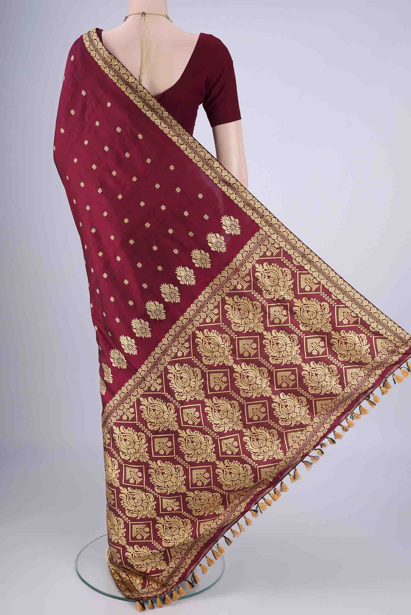 Flat view of Maroon Assam Silk Saree with Thread Butta on the body and Thread Border. 