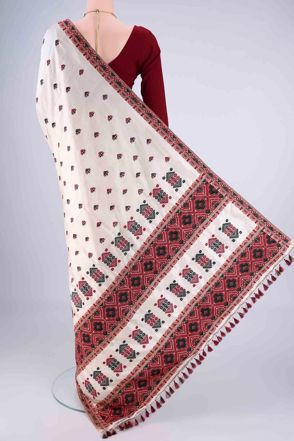 Flat view of Cream Assam Silk Saree with Thread Butta on the body and Thread Border. 