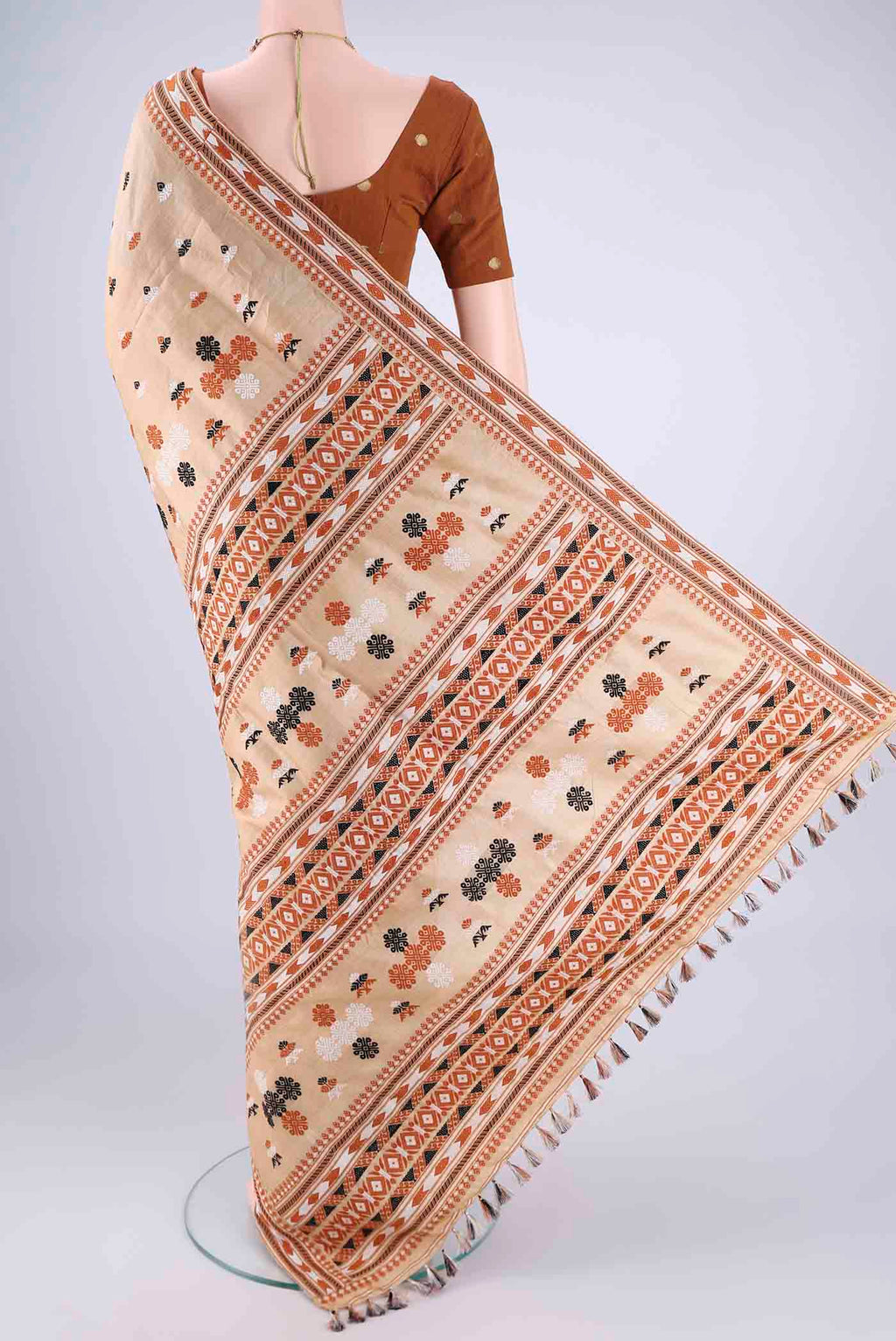 Flat view of Beige Assam Silk Saree with Thread Butta on the body and Thread Border. 