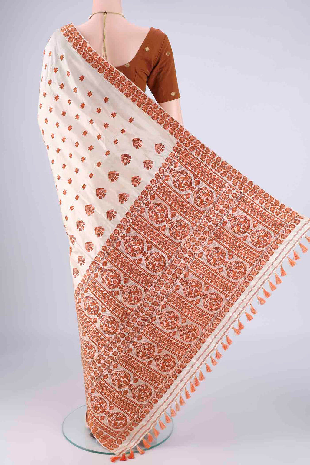 Flat view of Cream Assam Silk Saree with Thread Butta on the body and Thread Border. 