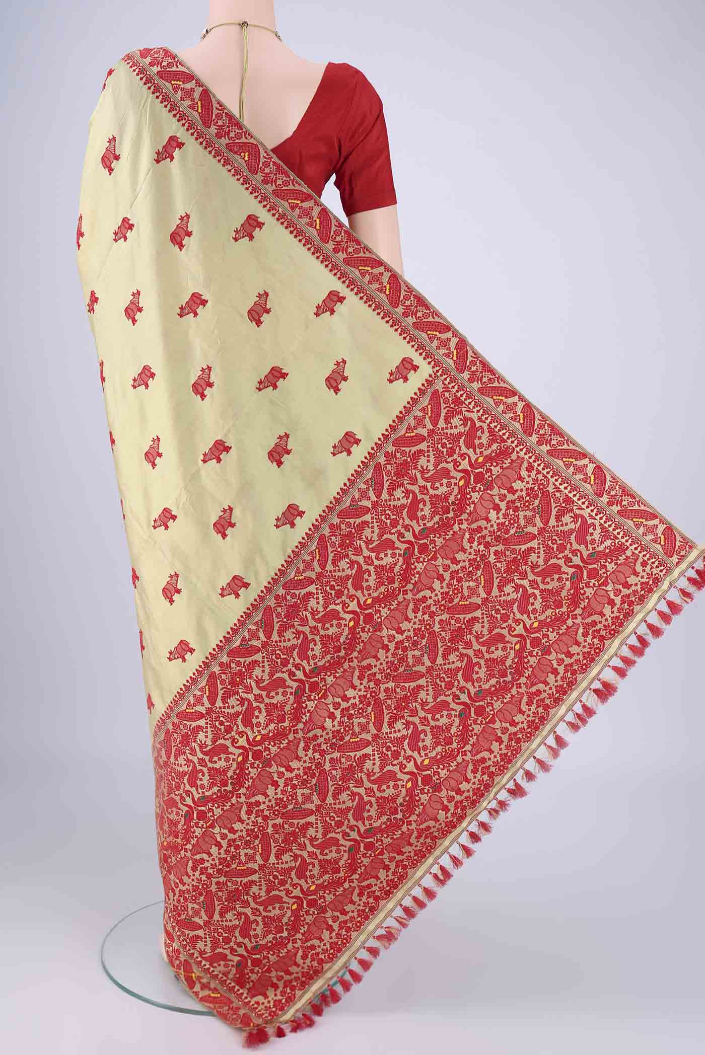 Flat view of Sage Green Assam Silk Saree with Thread Butta on the body and Thread Border. 