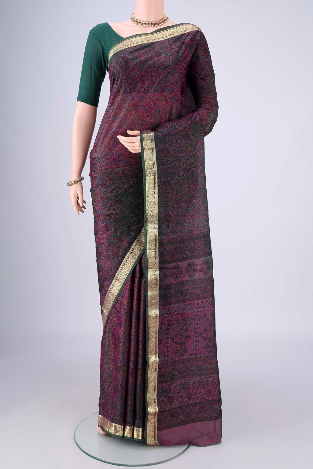 Purple Printed Silk Saree with Printed design on the body and Zari Border.  displayed on a mannequin
