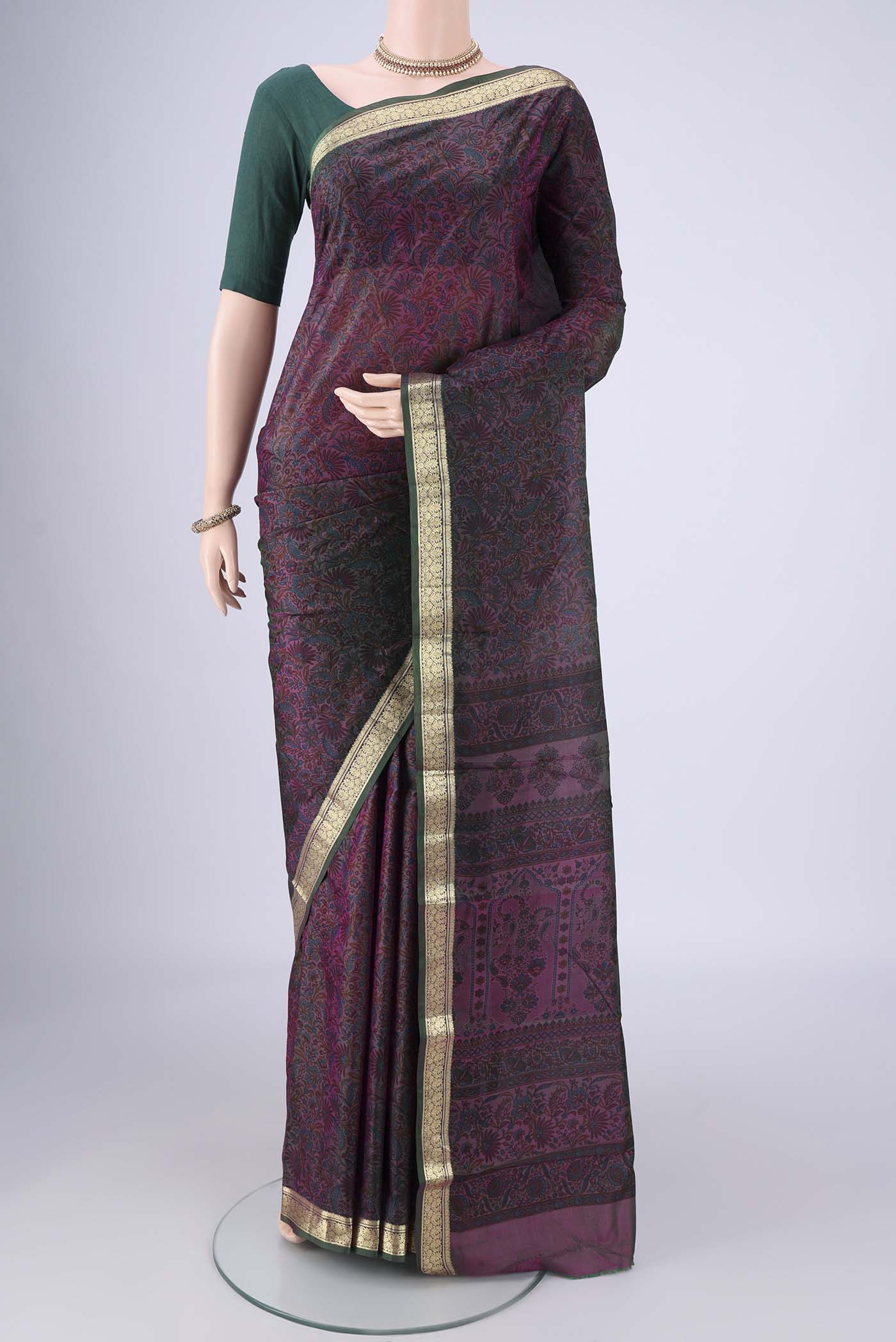 Purple Printed Silk Saree with Printed design on the body and Zari Border.  displayed on a mannequin