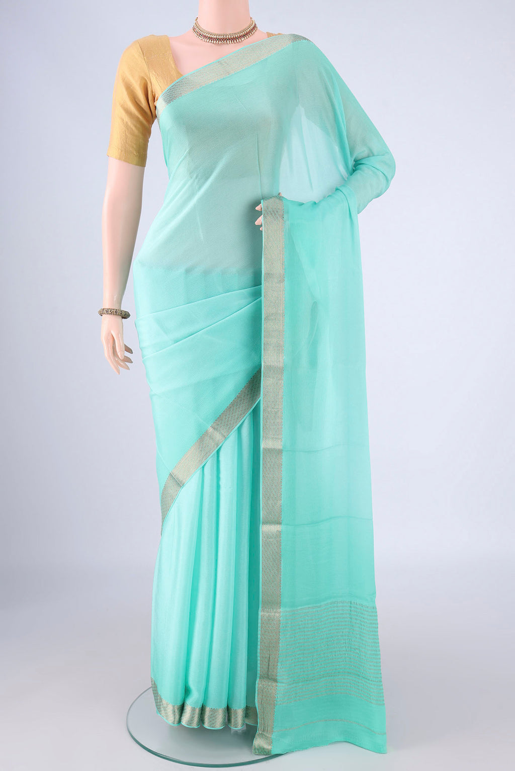 Sky Blue Mysore Chiffon Saree with Plain Body and Zari Border.  displayed on a mannequin