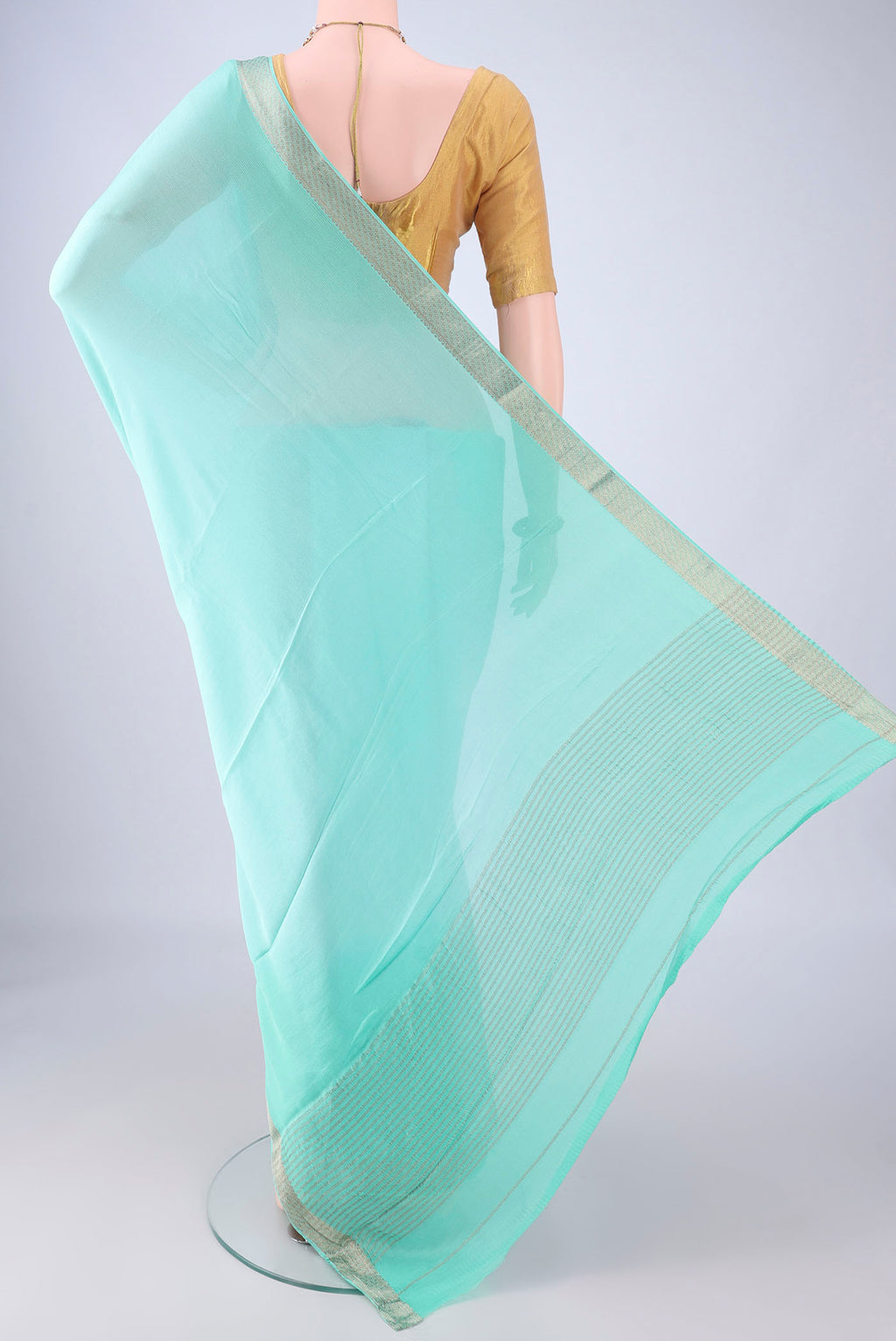 Flat view of Sky Blue Mysore Chiffon Saree with Plain Body and Zari Border. 