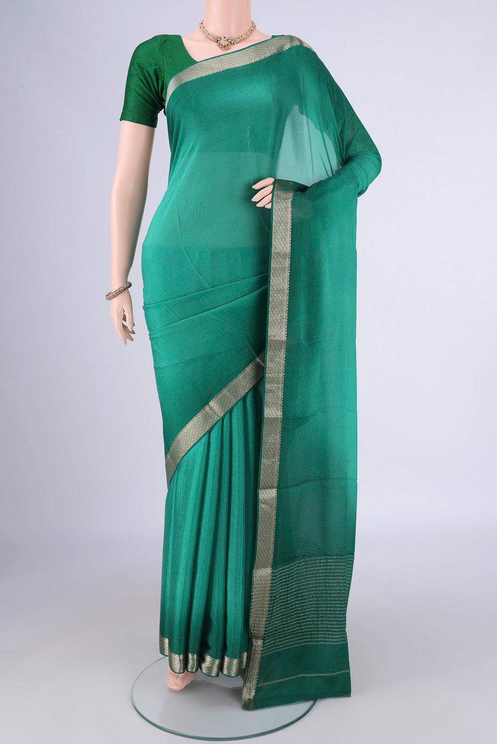 Sea Green Dual Tone Mysore Chiffon Saree with Plain Body and Zari Border.  displayed on a mannequin