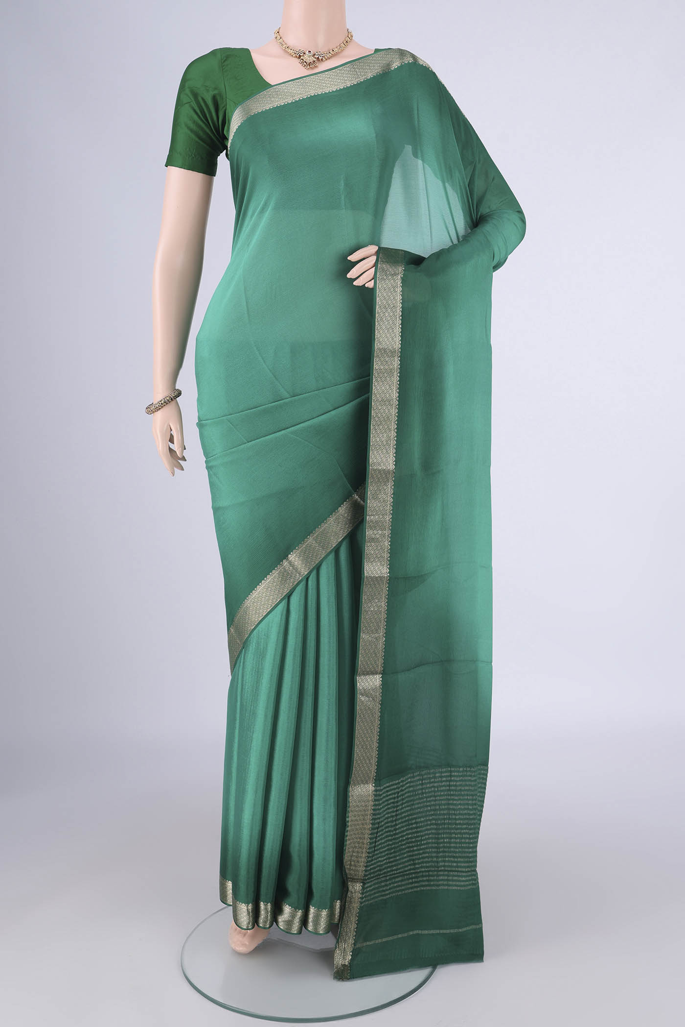 Sea Green Dual Tone Mysore Chiffon Saree with Plain Body and Zari Border.  displayed on a mannequin