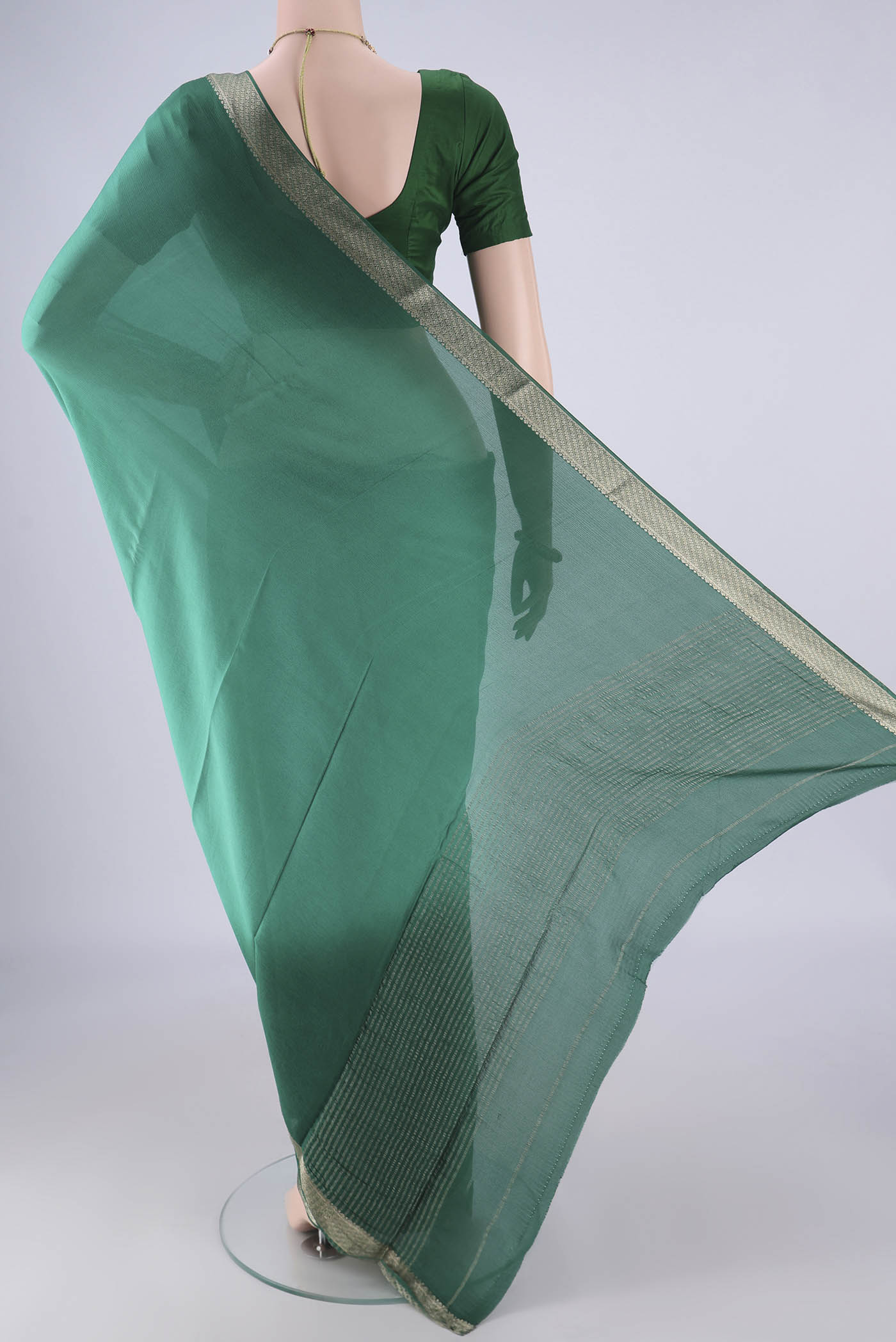 Flat view of Sea Green Dual Tone Mysore Chiffon Saree with Plain Body and Zari Border. 
