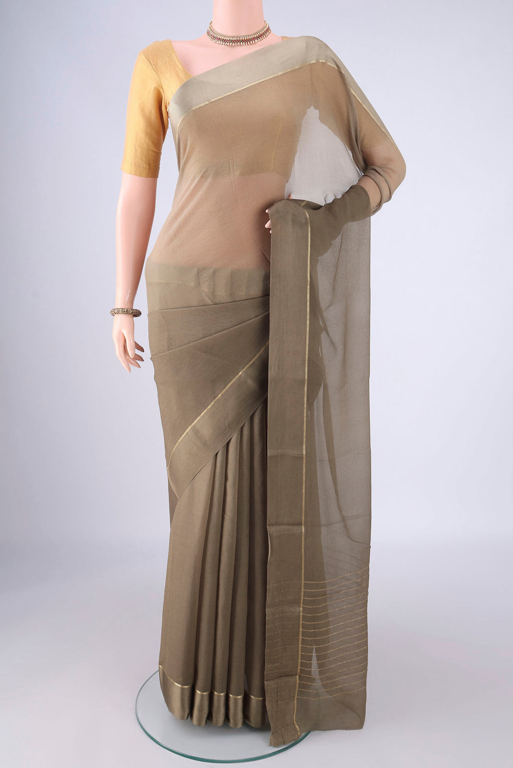 Dark Beige Mysore Chiffon Saree with Plain Body and Zari Border.  displayed on a mannequin