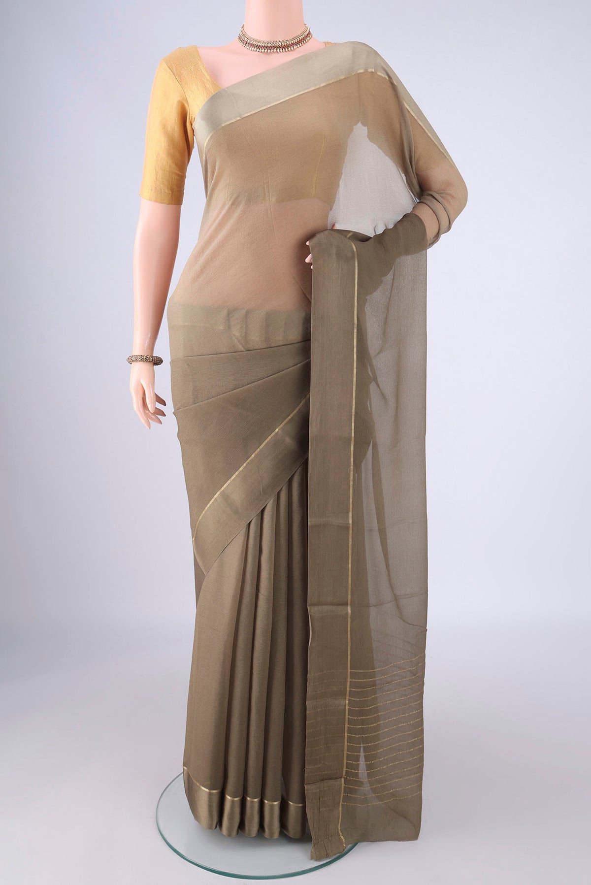 Dark Beige Mysore Chiffon Saree with Plain Body and Zari Border.  displayed on a mannequin