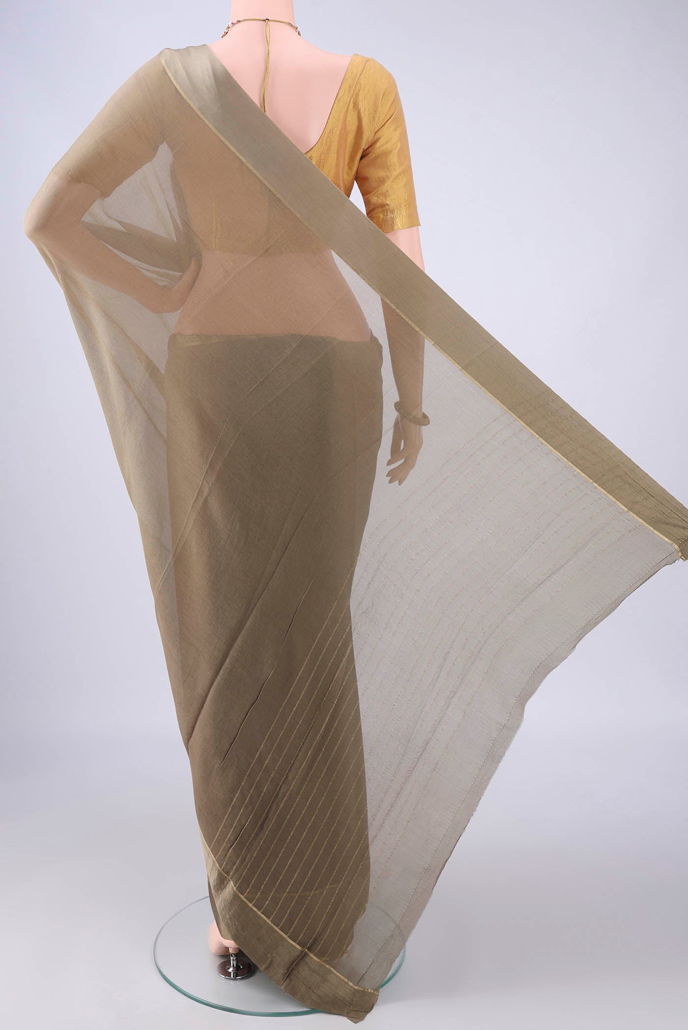 Flat view of Dark Beige Mysore Chiffon Saree with Plain Body and Zari Border. 