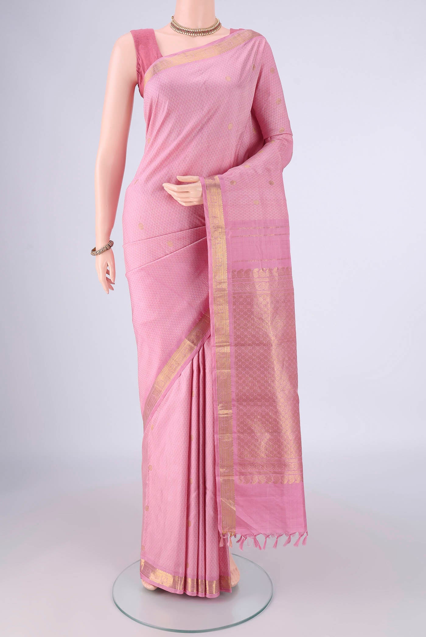 Rose pink Kanjivaram Silk Saree with Jacquard With Zari Butta on the body and Zari Border.  displayed on a mannequin