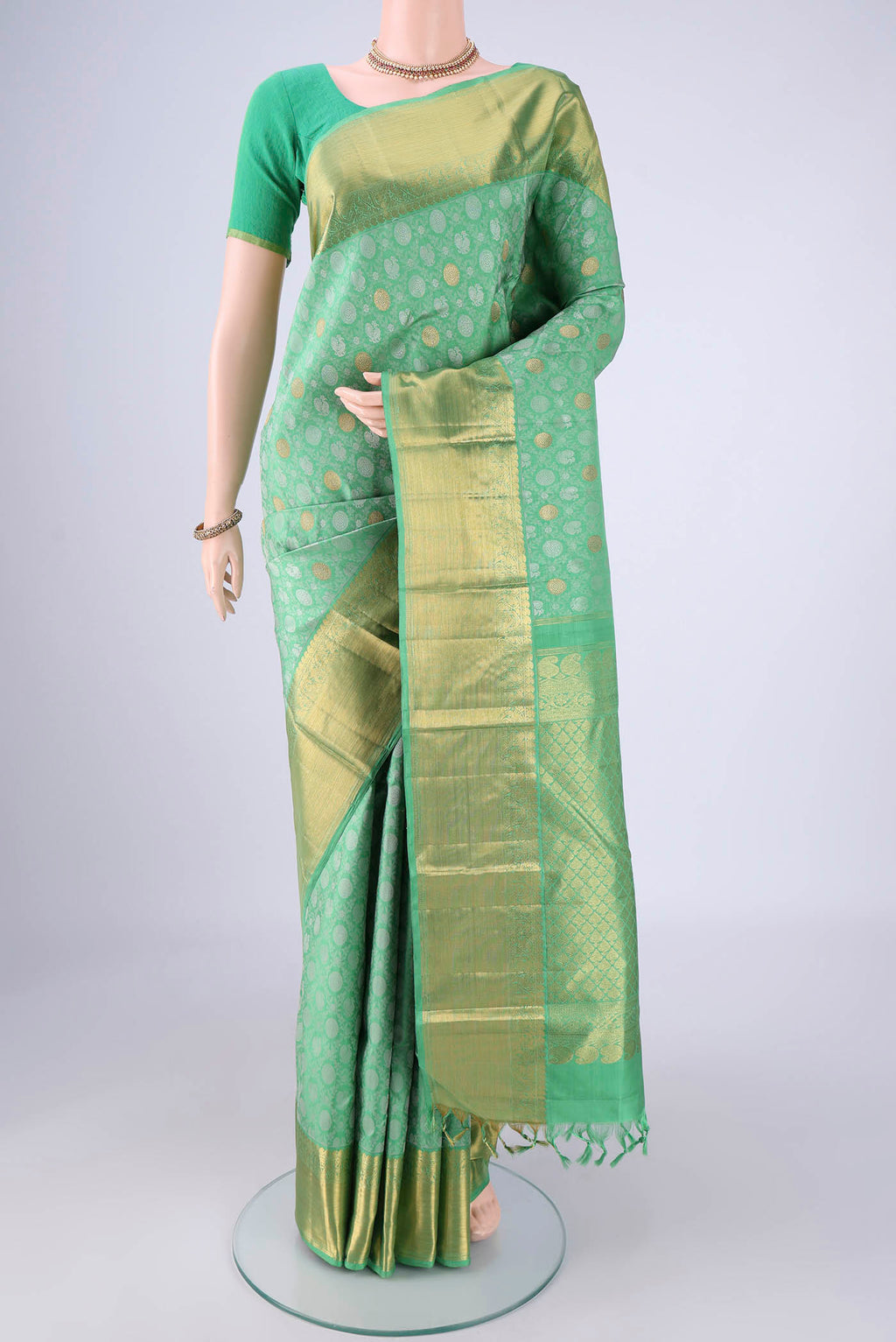Sea Green Kanjivaram Silk Saree with Jacquard With Zari Butta on the body and Zari Border.  displayed on a mannequin