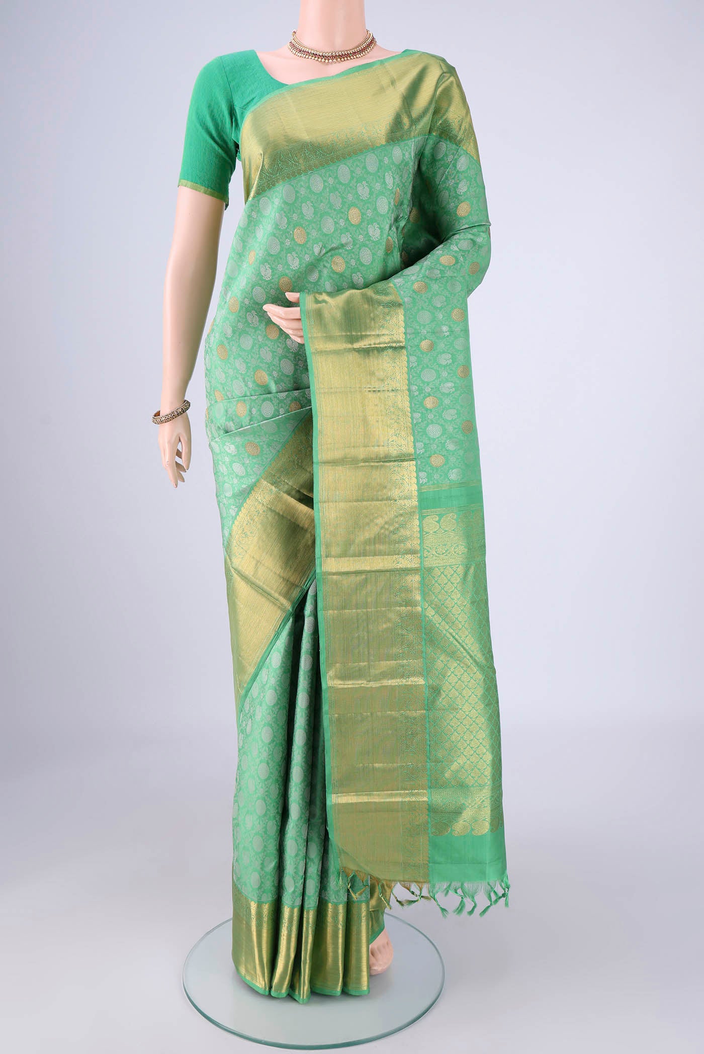 Sea Green Kanjivaram Silk Saree with Jacquard With Zari Butta on the body and Zari Border.  displayed on a mannequin