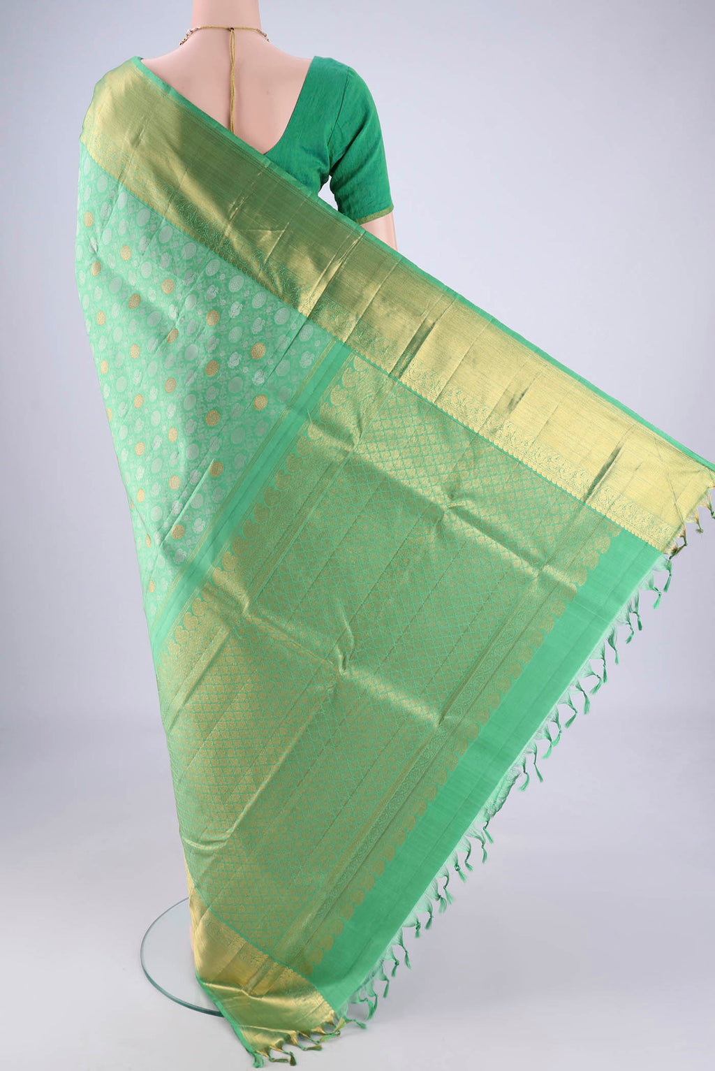 Flat view of Sea Green Kanjivaram Silk Saree with Jacquard With Zari Butta on the body and Zari Border. 