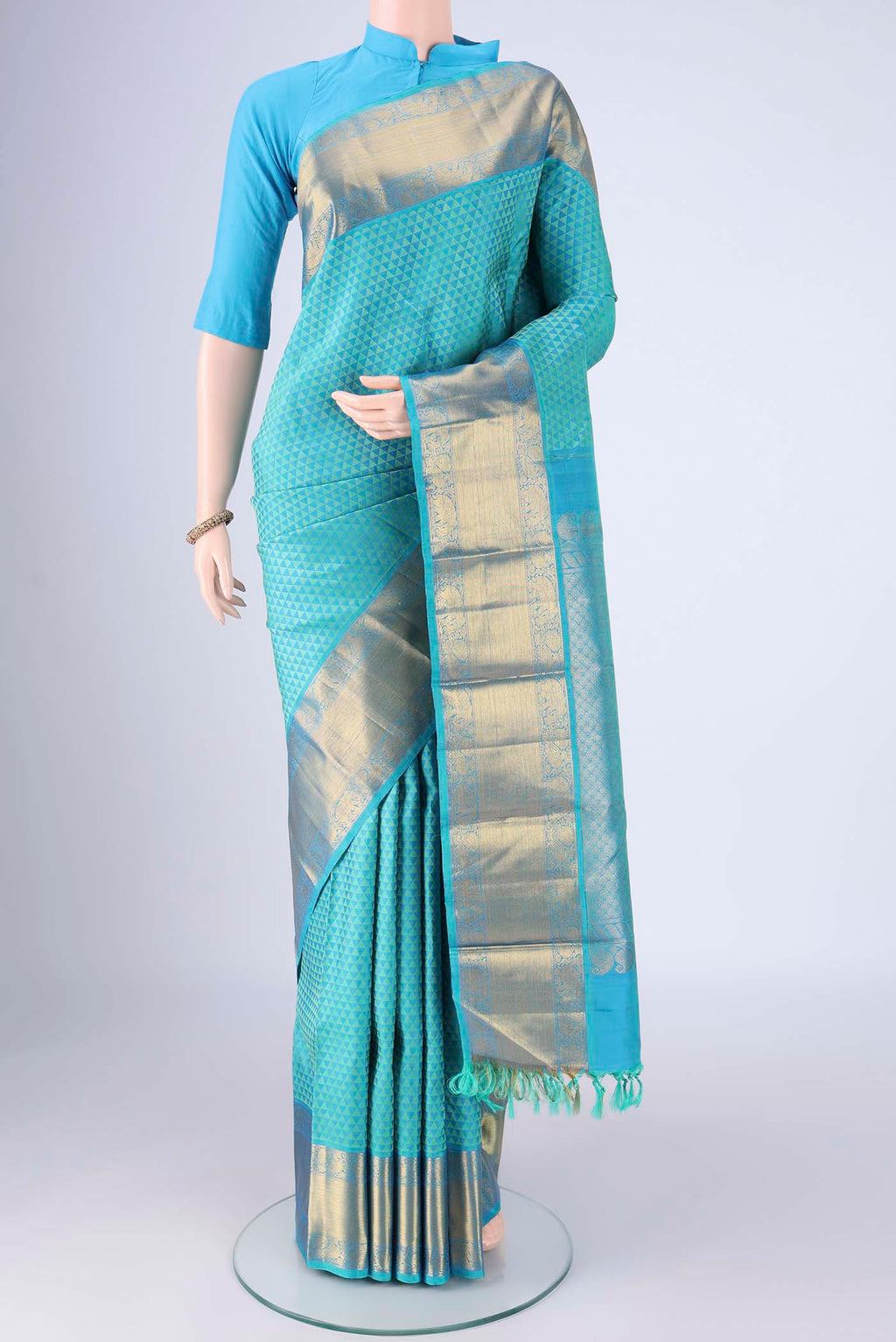 Turquoise Kanjivaram Silk Saree with Jacquard design on the body and Zari Border.  displayed on a mannequin