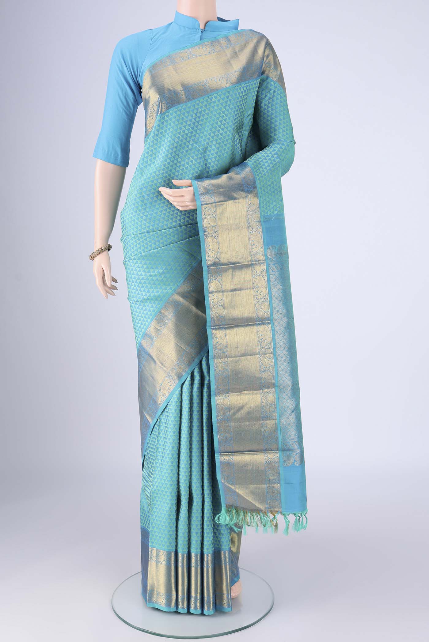 Turquoise Kanjivaram Silk Saree with Jacquard design on the body and Zari Border.  displayed on a mannequin