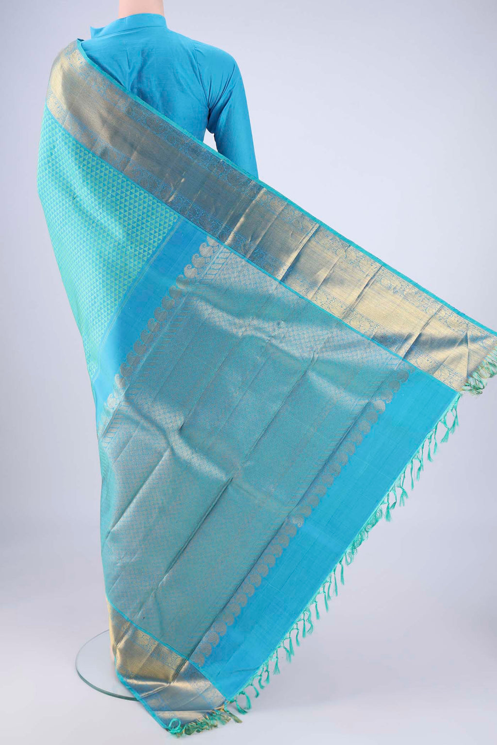 Flat view of Turquoise Kanjivaram Silk Saree with Jacquard design on the body and Zari Border. 