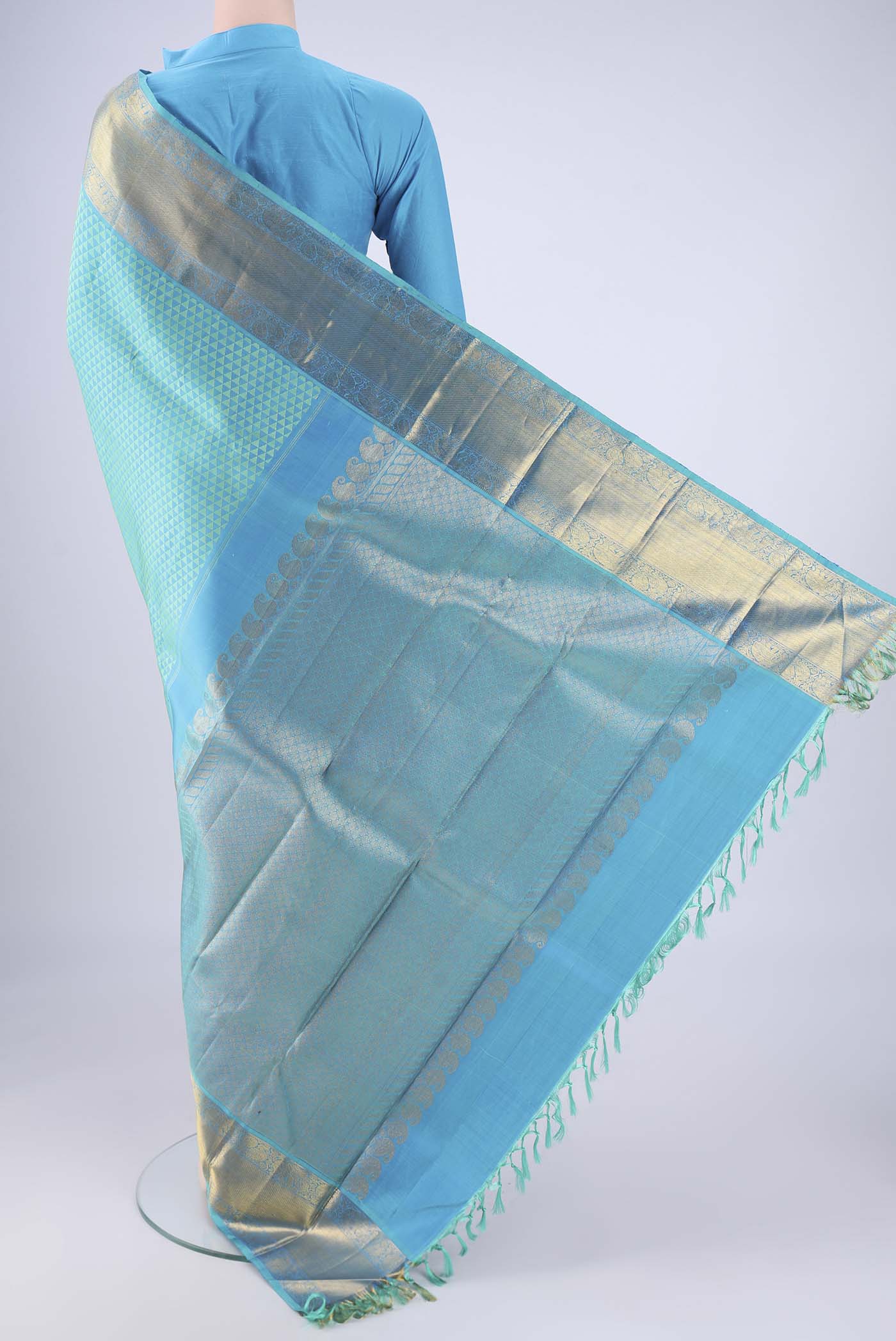 Flat view of Turquoise Kanjivaram Silk Saree with Jacquard design on the body and Zari Border. 