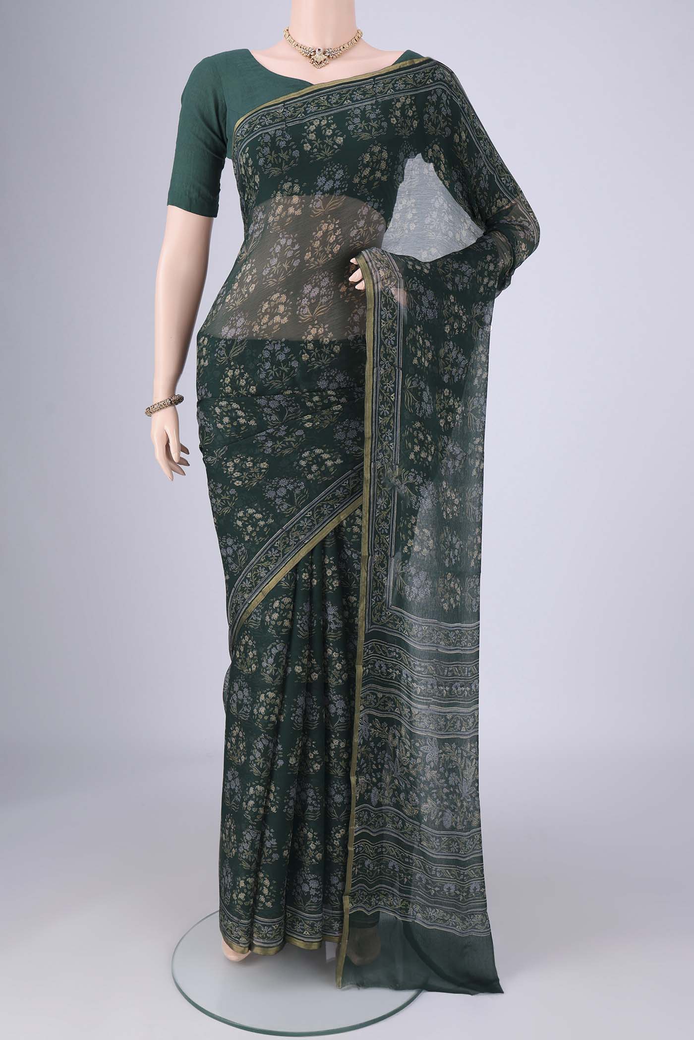 Bottle Green Mysore Chiffon Saree with Floral Print on the body and Thin Zari Line.  displayed on a mannequin