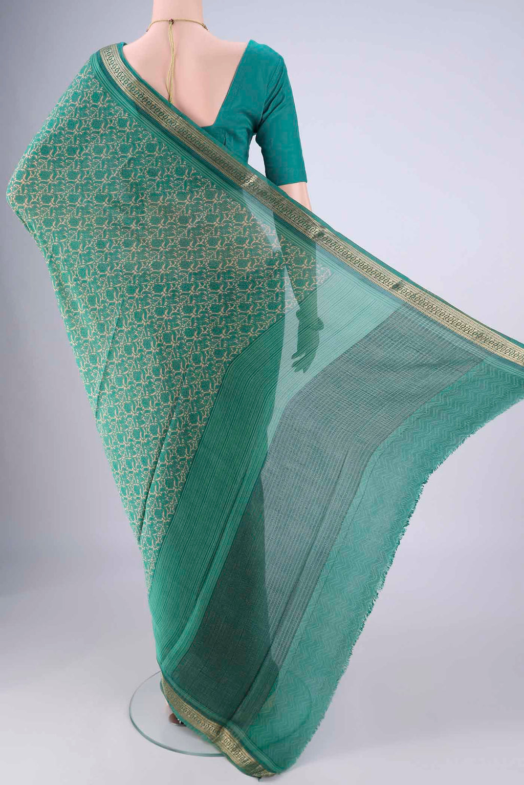 Flat view of Sea Green Mysore Crepe Saree with Printed design on the body and Zari Border. 