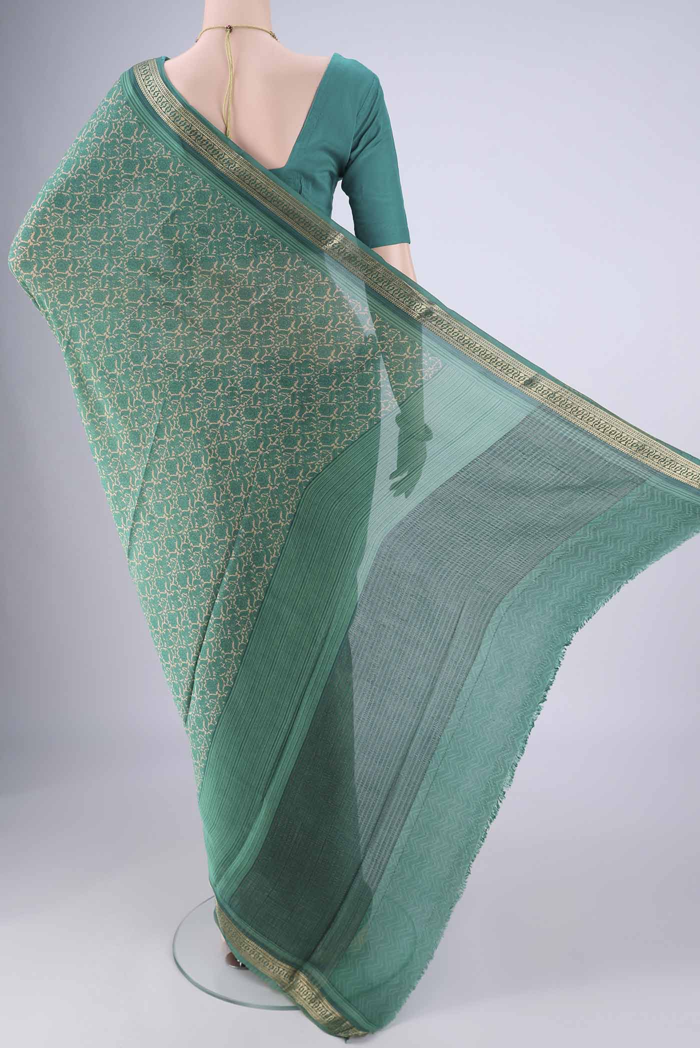 Flat view of Sea Green Mysore Crepe Saree with Printed design on the body and Zari Border. 